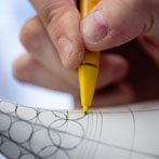 Rhian Malin decorating a mandala bottle in her workshop 2019